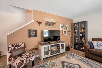 Living area featuring wood finished floors and bas