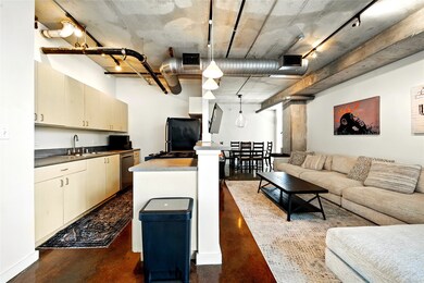 Another view of the kitchen and living room