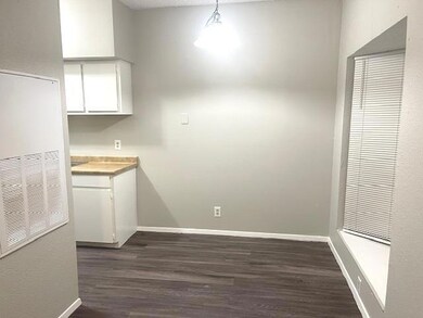 Unfurnished dining area with dark wood-type floor