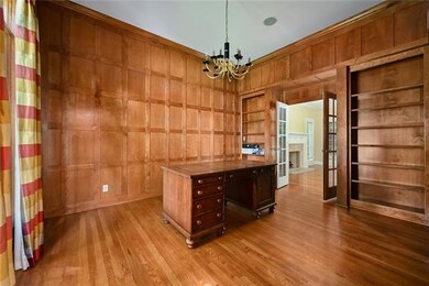 Office has wood paneling and 12 foot ceilings.