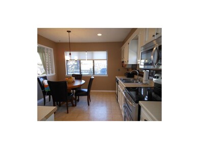 Light-filled kitchen has large eating space.