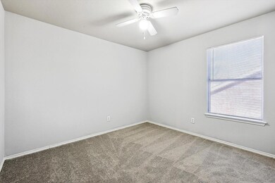 Empty room featuring carpet floors and ceiling fan