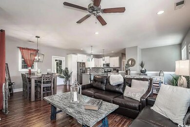 Living area featuring dark wood-style floors, visi