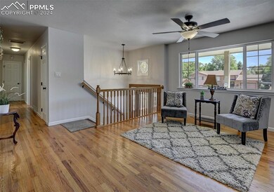 Sitting room featuring ceiling fan with notable ch