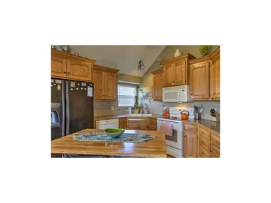 Island kitchen has tons of cabinets and plenty of 