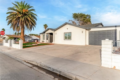 Ranch-style house featuring a fenced front yard, concrete driveway, stucco siding, an attached garage, and a gate