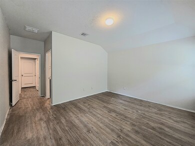 Spacious master bedroom featuring elegant flooring