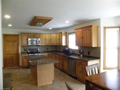 Spacious Kraftmaid kitchen complete with granite c