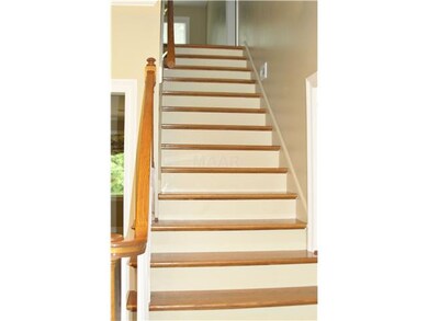 Beautiful oak staircase leading to loft area.