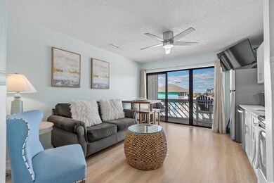 Living area featuring visible vents, a textured ce