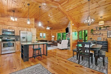 Dining space with light wood-type flooring, wooden walls, a chandelier, wood ceiling, and lofted ceiling