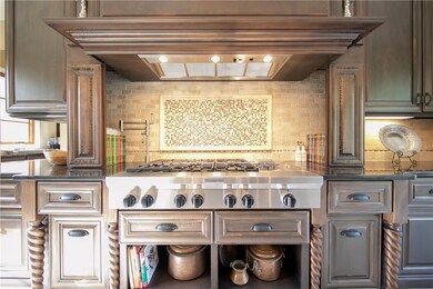 Beautiful gas cooktop with storage on sides for cookbooks or spices; pot filler