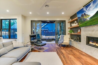 Living room featuring wood finished floors, a cei