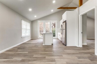 Kitchen featuring white cabinets, baseboards, loft