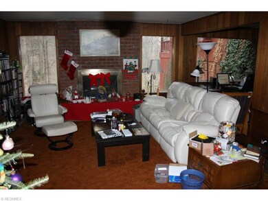 Living room has brick fireplace and hearth framed 