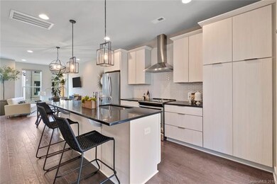 Sample kitchen, dining looking into family room. N