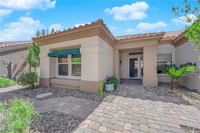 Property entrance with a tiled roof and stucco sid