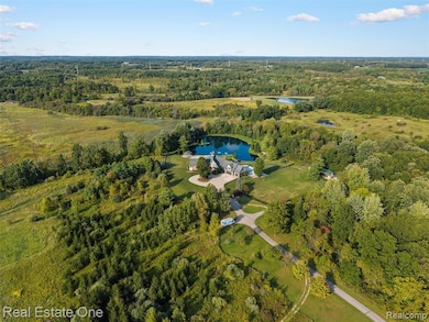 Aerial overview of property's location with a heavily wooded area and a large body of water