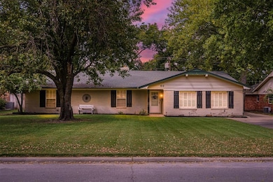 Ranch-style house with a lawn and central AC