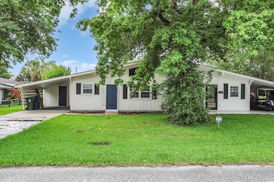 Ranch-style house with an attached carport and driveway