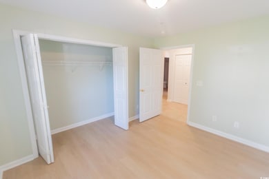 Unfurnished bedroom featuring light wood-type flooring and a closet
