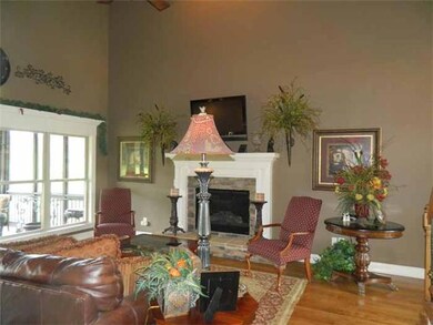 Great Room: 17 x 15: Open and inviting room with hardwood flooring, soaring 17+ ceiling, gas fireplace with logs, stacked stone hearth and detailed wood mantle,  