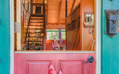 Dutch Door opens to entry with bench to remove shoes and hooks for jackets.