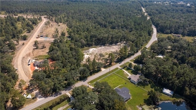 Aerial overview of property's location with a heavily wooded area