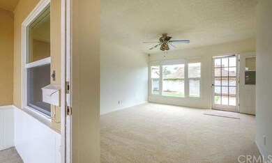The bright and welcoming living room greets you in