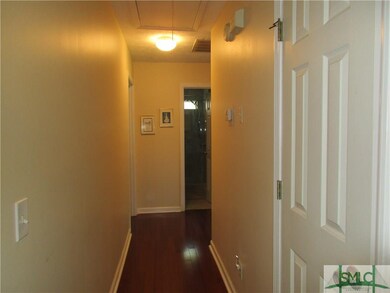 Hardwood flooring in hallway and guest bedroom