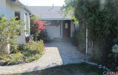 Welcoming front walk with bouganvilla and wisteria
