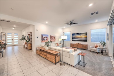 Living area featuring ceiling fan and recessed lig