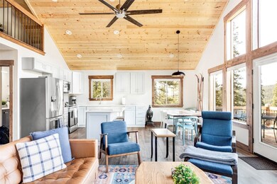 Living room with high vaulted ceiling, light hardw