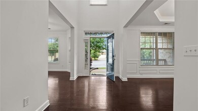 Foyer featuring crown molding, wood finished floors, and baseboards