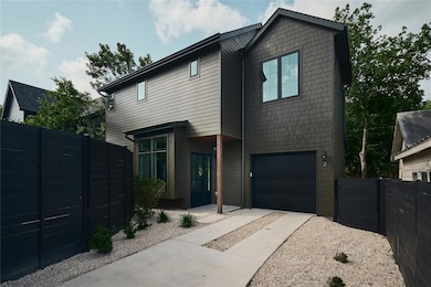 View of front facade with driveway and a garage