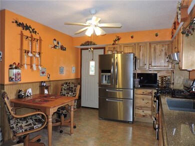 The eat in kitchen has Custom hickory cabinets and