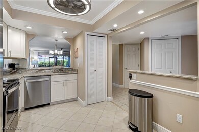 Kitchen featuring white cabinets, ornamental moldi