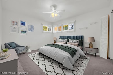 Primary bedroom with ceiling fan and baseboards