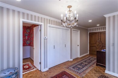 Another view of entry way, powder bath and storage