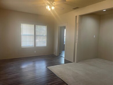 Empty room with dark hardwood / wood-style floorin