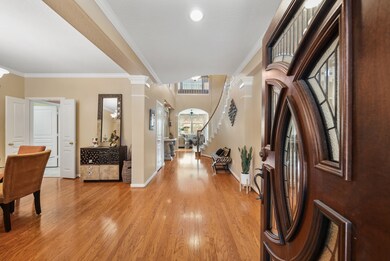 Upon entering, you are greeted with grand features including the custom front door.
