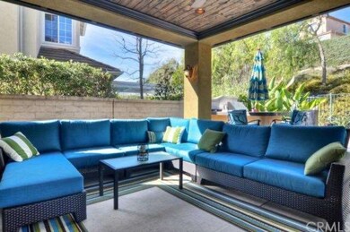 Outside, covered sitting area overlooking the pool