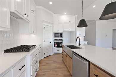 Kitchen with light stone countertops, white cabine