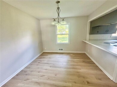 Unfurnished dining area with light wood finished floors and baseboards