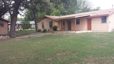Rear view of property with a patio and a yard