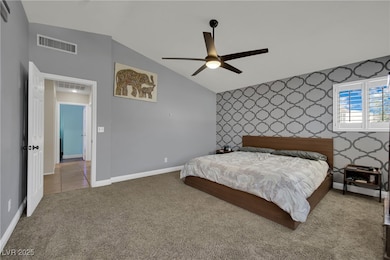 Bedroom featuring wallpapered walls, carpet floors