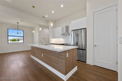 Kitchen with wall chimney exhaust hood, a kitchen