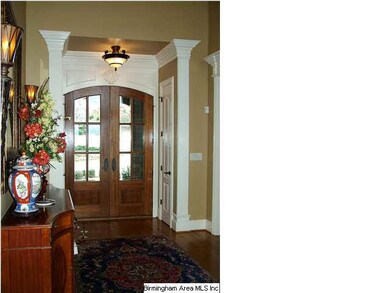Foyer with exquiste moldings, hardwood floors and 