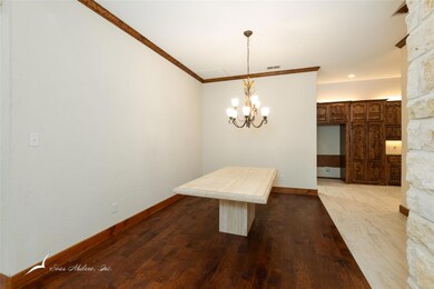 Dining area featuring elegant, ornate columns that