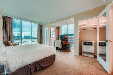 Carpeted bedroom with ornamental molding and baseboards